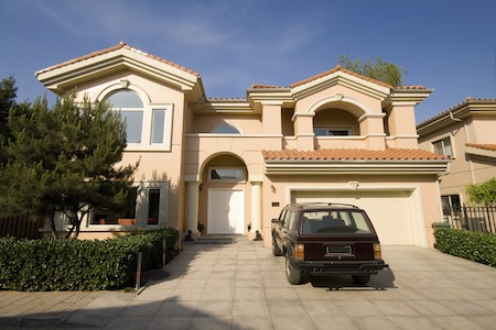 view of a home with a car in the driveway
