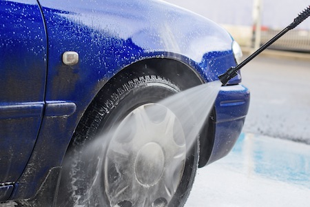 Blue car wash using high pressure water jet.