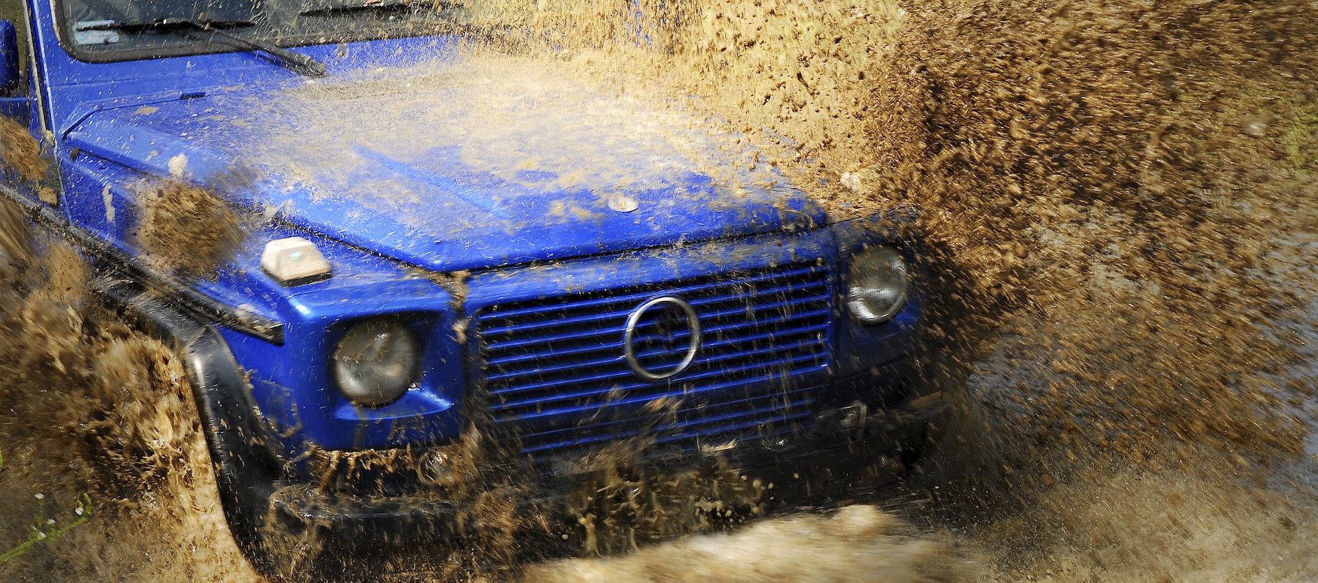 Off road car crossing deep mud