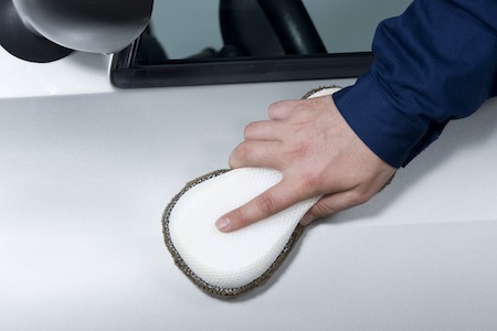 Man waxing a car