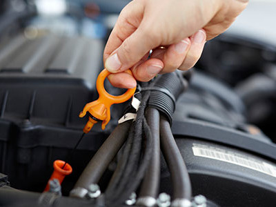 man checking his dip stick for oil
