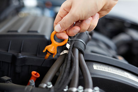 man checking his dip stick for oil