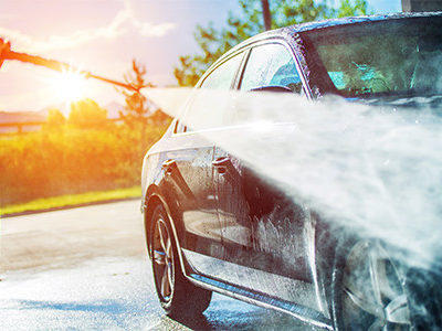 Person Pressure Washing Their Car